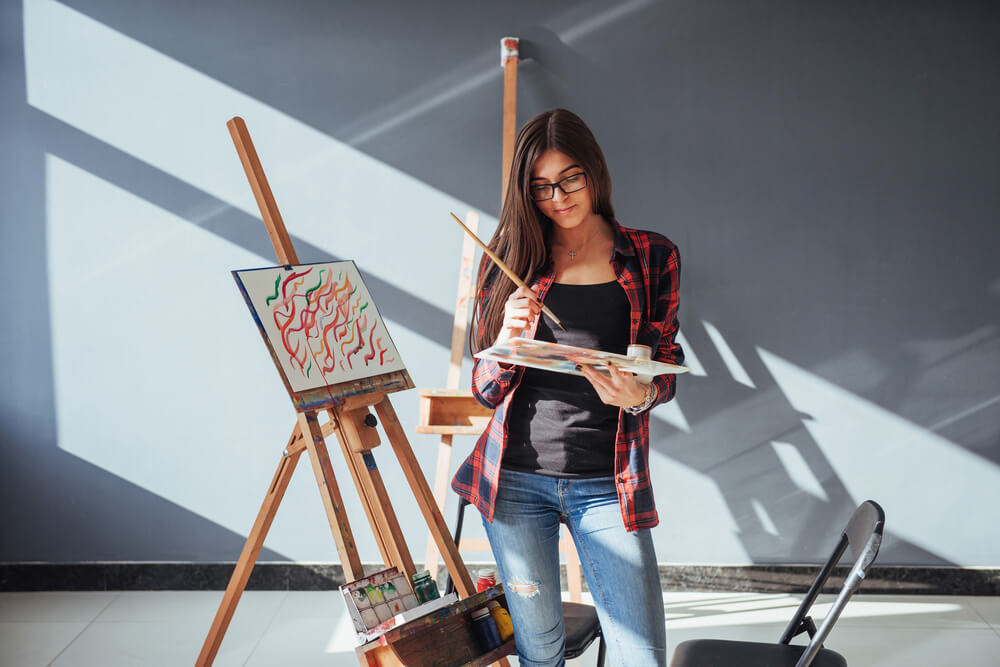 woman painting with easel