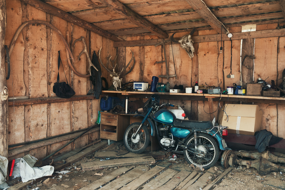 Green motorcycle stored in a shed