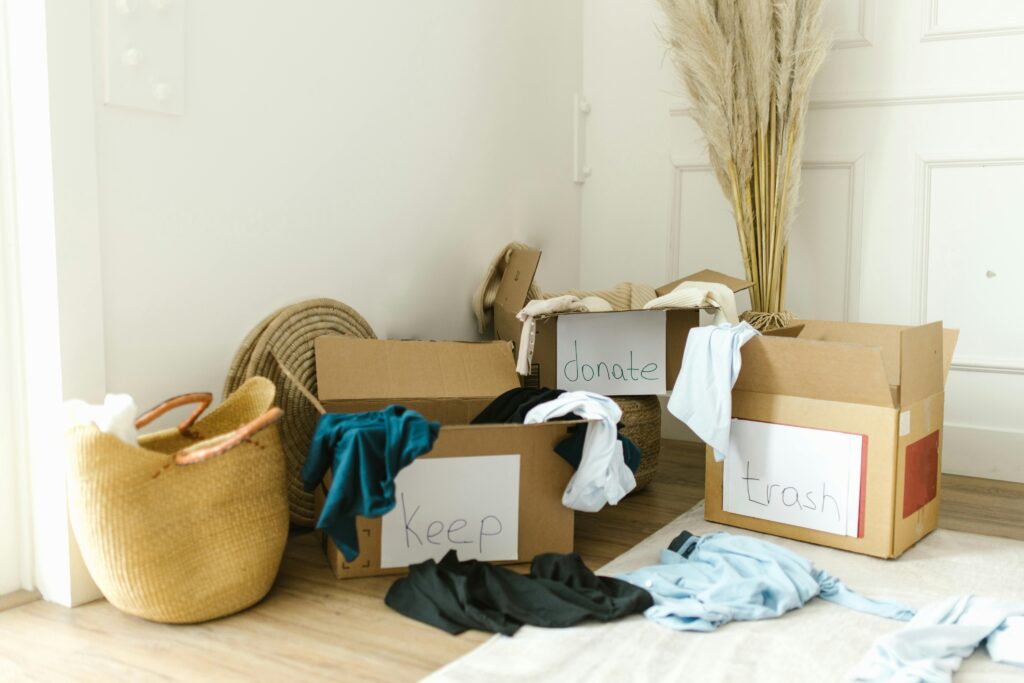 pexels-photo-8581372-8581372 Cardboard boxes labeled 'Keep', 'Donate', and 'Trash' for home decluttering.